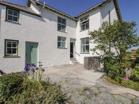 An exterior view of a house with plants and a pathway at Ty Mawr Farm in Llanfairpwllgwyngyll