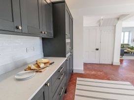 A kitchen with cabinets and bread on a countertop at Ty Mawr Farm in Llanfairpwllgwyngyll