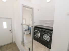 A laundry room with a washing machine and dryer at Ty Mawr Farm Llanfairpwllgwyngyll