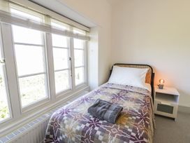 A bedroom with a single bed and a lamp on a nightstand at Ty Mawr Farm in Llanfairpwllgwyngyll
