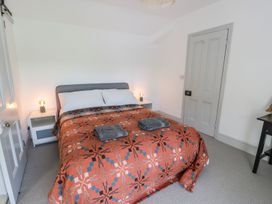 A bedroom with a bed and nightstand at Ty Mawr Farm Llanfairpwllgwyngyll
