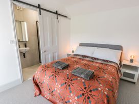 A bedroom with a bed and a washbasin at Ty Mawr Farm in Llanfairpwllgwyngyll