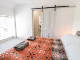 A bedroom with a bed and towels on top at Ty Mawr Farm in Llanfairpwllgwyngyll
