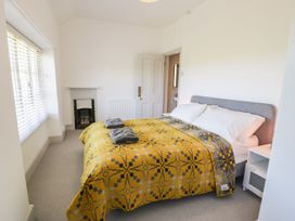 A bedroom with a bed and towels at Ty Mawr Farm in Llanfairpwllgwyngyll