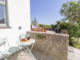 An outdoor seating area with a table and chairs at Ty Mawr Farm in Llanfairpwllgwyngyll