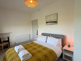 A bedroom featuring a bed with linens and pillows at Ty Mawr Farm Penmynydd near Llanfairpwllgwyngyll