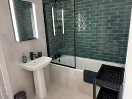A bathroom with a bath tub and wash basin at Ty Mawr Farm in Penmynydd near Llanfairpwllgwyngyll