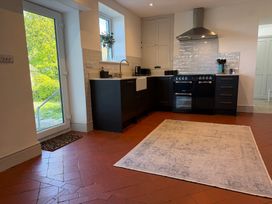 A kitchen with a stove, sink, and cabinets at Ty Mawr Farm in Penmynydd near Llanfairpwllgwyngyll