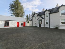 A house with a garage and driveway at Greenfield House Aughavas
