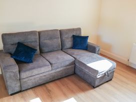 A sofa with cushions at Greenfield House in Aughavas