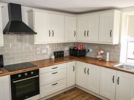 A kitchen with cabinets, countertop, and appliances at Greenfield House in Aughavas