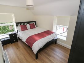 A bedroom with a bed and bedside table at Greenfield House in Aughavas