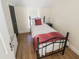 A bedroom with a single bed and bedside table at Greenfield House in Aughavas
