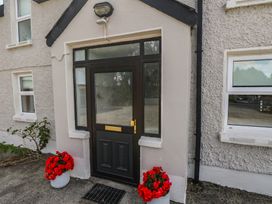 An entryway with a door and flower pots at Greenfield House Aughavas, County Leitrim