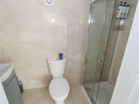 A bathroom featuring a shower, toilet, and sink at Greenfield House in Aughavas, County Leitrim