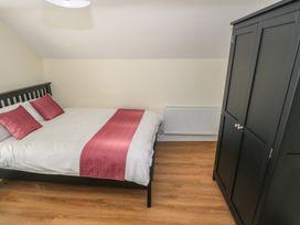 A bedroom with a bed and wardrobe at Greenfield House, Aughavas, County Leitrim