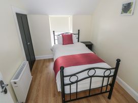 A bedroom with a single bed and nightstand at Greenfield House in Aughavas, County Leitrim