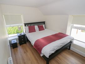 A bedroom with a double bed and nightstand at Greenfield House Aughavas, County Leitrim