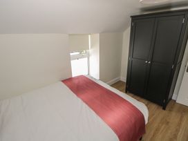 A bedroom with a bed and wardrobe at Greenfield House in Aughavas, County Leitrim