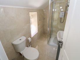 A bathroom with a toilet, shower, and sink at Greenfield House Aughavas County Leitrim