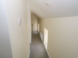 A hallway with a radiator and windows at Greenfield House in Aughavas, County Leitrim