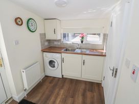 A kitchen with a sink and washing machine at Greenfield House in Aughavas, County Leitrim