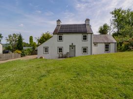 A house with solar panels and grass area at Cynefin in Newport, Pembrokeshire