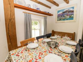 A dining room with a table set for meals at Cynefin in Newport, Pembrokeshire