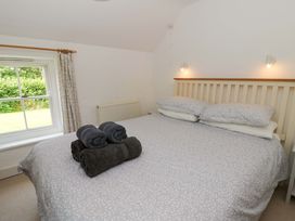 A bedroom with a bed and towels at Cynefin in Newport, Pembrokeshire