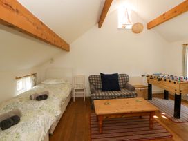 A bedroom with a bed and foosball table at Cynefin Newport, Pembrokeshire