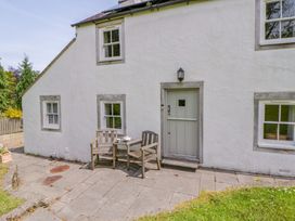 An outdoor seating area with chairs and a table at Cynefin, Newport, Pembrokeshire