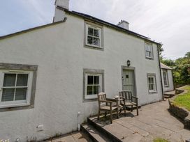 A house with a table and chairs on the patio at Cynefin in Newport, Pembrokeshire