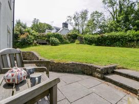 A garden with a teapot and mugs on a table at Cynefin in Newport, Pembrokeshire
