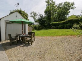 A garden area with a table and chairs at Cynefin in Newport, Pembrokeshire