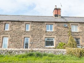 A stone house with windows and a door at Shepherds Nook in Chathill