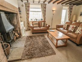 A living room with a fireplace and sofas at Shepherds Nook in Chathill