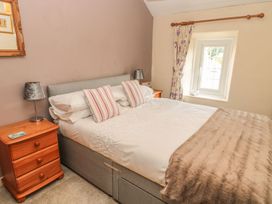 A bedroom with a bed and bedside table at Shepherds Nook in Chathill