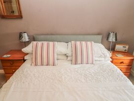 A bedroom with a bed and nightstands at Shepherds Nook in Chathill
