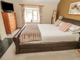A bedroom with a bed and dresser at Shepherds Nook in Chathill