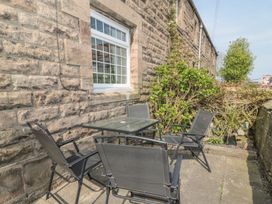 An outdoor seating area with a table and chairs at Shepherds Nook in Chathill