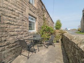 An outdoor seating area with a table and chairs at Shepherds Nook in Chathill