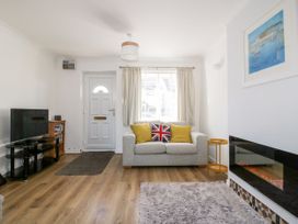 A living room with a sofa and television at Seahorses in Padstow