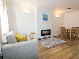A living room with a sofa and dining table at Seahorses in Padstow