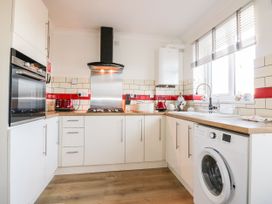 A kitchen with appliances and a sink at Seahorses in Padstow