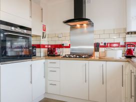 A kitchen with an oven, gas stove and kettle at Seahorses Padstow