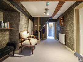 A hallway with furniture and decor at Plas Dolguog in Machynlleth