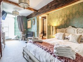 A bedroom with a bed and a television at Plas Dolguog in Machynlleth