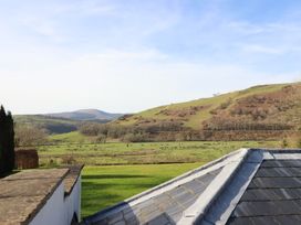 A landscape view featuring hills and grass at Plas Dolguog in Machynlleth