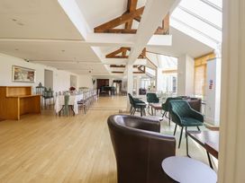 A dining room with tables and chairs at Plas Dolguog in Machynlleth