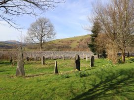 A landscape with stone formations and trees at Plas Dolguog Machynlleth